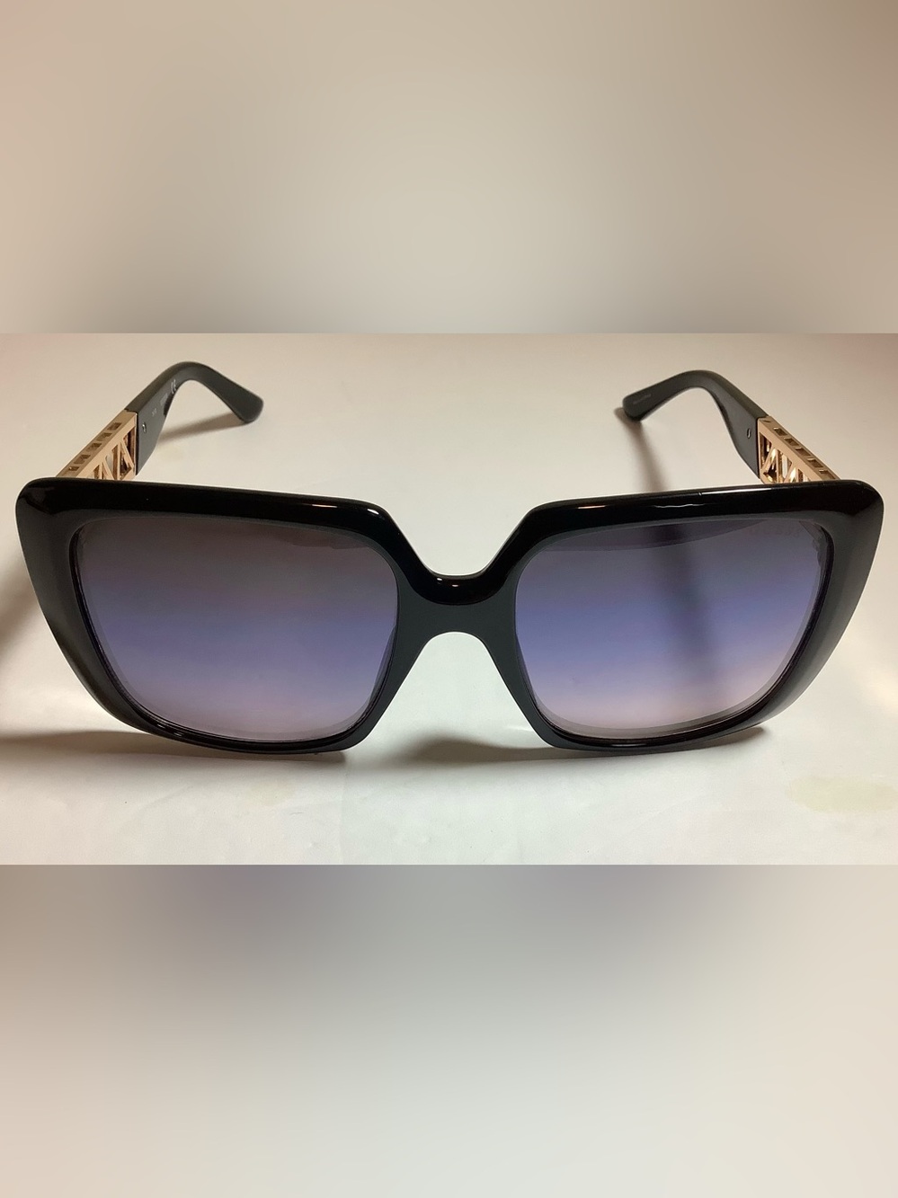 Guest oversize square sunglasses featuring a thick, black acetate frame.
